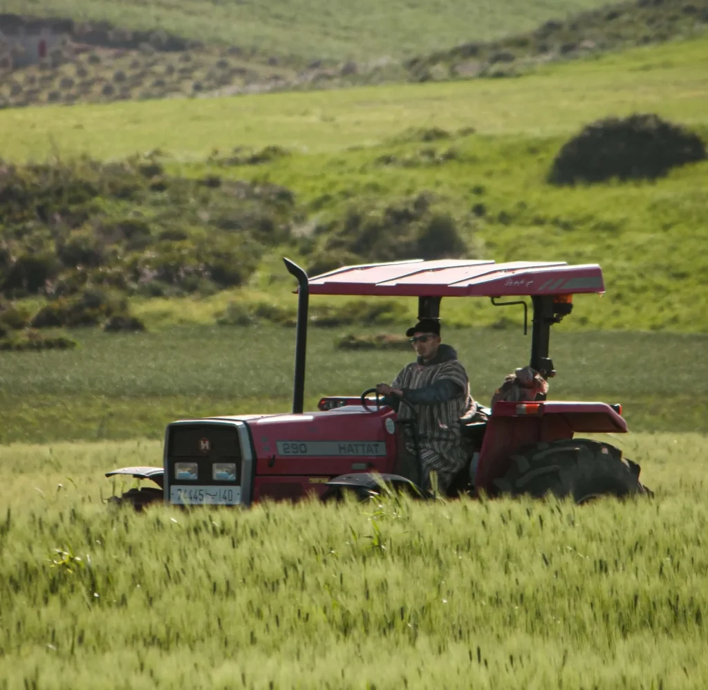 Tractor working on a large Australian farm field, representing NB Coir's bulk coco peat supply for commercial agriculture yield-boosting soil alternatives.